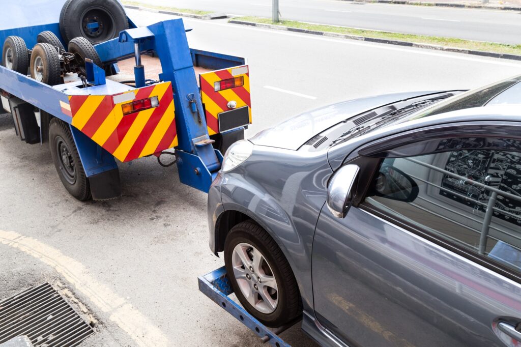 tow-truck-towing-a-broken-down-car-on-the-street.jpg